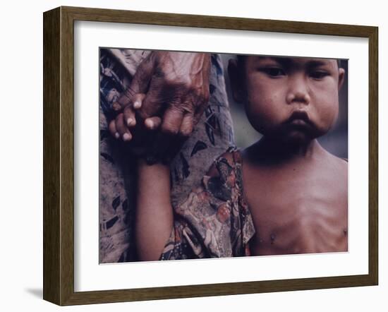 Close-Up of an Indonesian Child Holding on to the Hand of His Mother-Co Rentmeester-Framed Photographic Print