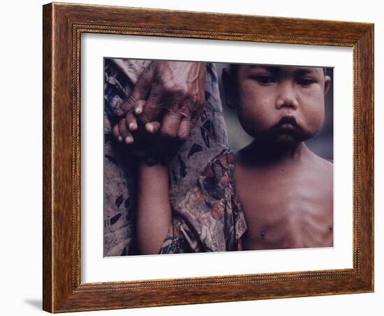 Close-Up of an Indonesian Child Holding on to the Hand of His Mother-Co Rentmeester-Framed Photographic Print