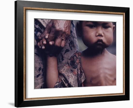 Close-Up of an Indonesian Child Holding on to the Hand of His Mother-Co Rentmeester-Framed Photographic Print