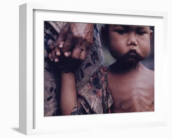 Close-Up of an Indonesian Child Holding on to the Hand of His Mother-Co Rentmeester-Framed Photographic Print