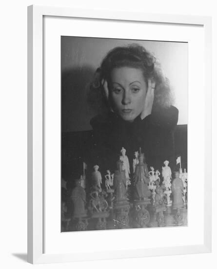 Close Up of Danielle Darrieux Looking at Chess Pieces-David Scherman-Framed Premium Photographic Print