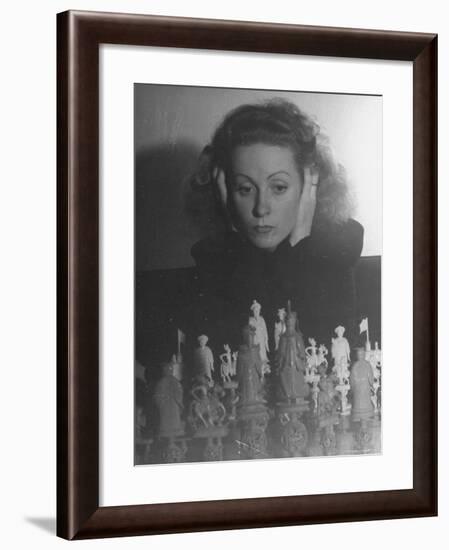 Close Up of Danielle Darrieux Looking at Chess Pieces-David Scherman-Framed Premium Photographic Print