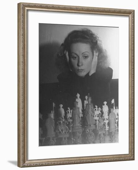 Close Up of Danielle Darrieux Looking at Chess Pieces-David Scherman-Framed Premium Photographic Print