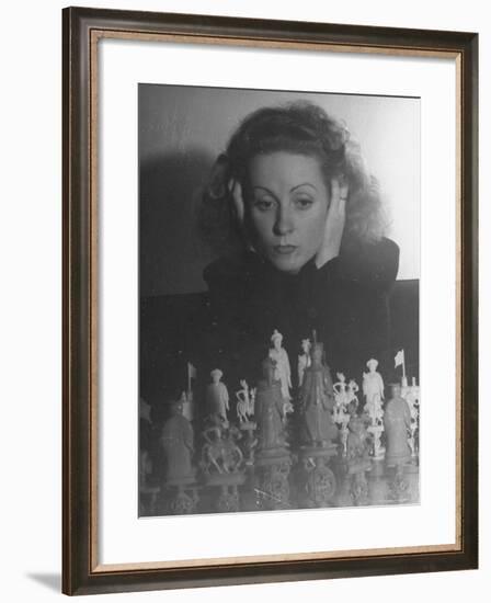 Close Up of Danielle Darrieux Looking at Chess Pieces-David Scherman-Framed Premium Photographic Print