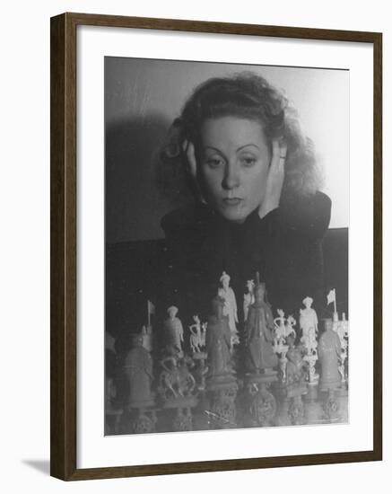 Close Up of Danielle Darrieux Looking at Chess Pieces-David Scherman-Framed Premium Photographic Print