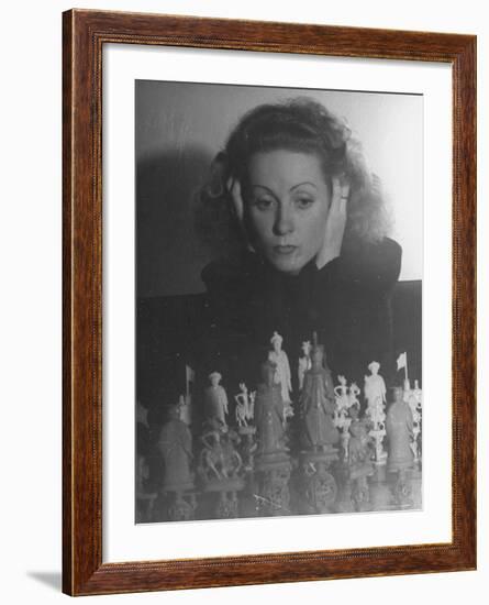 Close Up of Danielle Darrieux Looking at Chess Pieces-David Scherman-Framed Premium Photographic Print