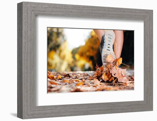 Close up of Feet of a Runner Running in Autumn Leaves Training for Marathon and Fitness Healthy Lif-warrengoldswain-Framed Photographic Print