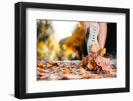 Close up of Feet of a Runner Running in Autumn Leaves Training for Marathon and Fitness Healthy Lif-warrengoldswain-Framed Photographic Print