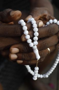 Close-up of hands of African Muslim man praying with Islamic prayer beads  (tasbih), Togo' Photographic Print - Godong | Art.com
