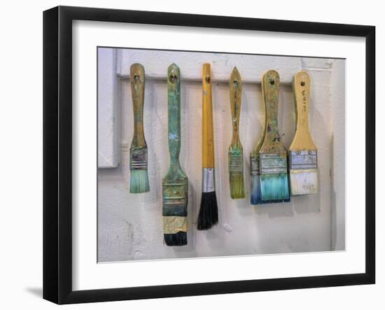 Close-up of paint brushes hanging on wall at an artist studio, California, USA-Panoramic Images-Framed Photographic Print