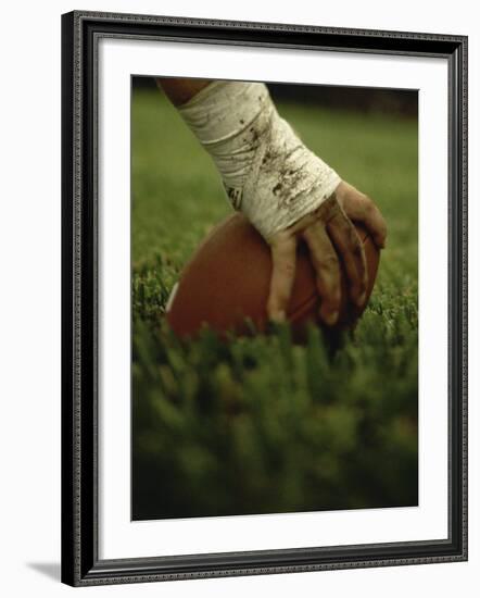 Close-up of the Hand of an American Football Player Holding a Football--Framed Photographic Print