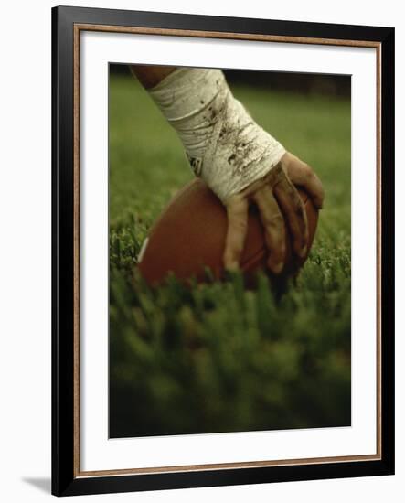 Close-up of the Hand of an American Football Player Holding a Football-null-Framed Photographic Print