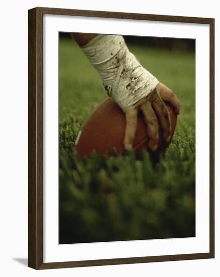 Close-up of the Hand of an American Football Player Holding a Football--Framed Photographic Print