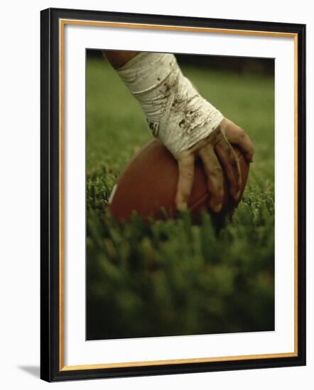 Close-up of the Hand of an American Football Player Holding a Football--Framed Photographic Print