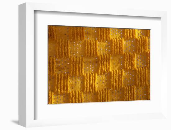 Close-up of vertical rug, hanged to the wall, used as decoration.-Michele Molinari-Framed Photographic Print