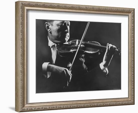 Close Up of Violinist Jascha Heifetz Playing in Mili's Darkened Studio-Gjon Mili-Framed Premium Photographic Print