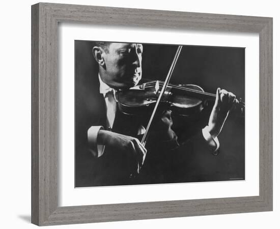Close Up of Violinist Jascha Heifetz Playing in Mili's Darkened Studio-Gjon Mili-Framed Premium Photographic Print