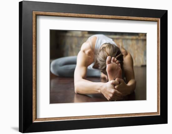 Close up of Young Woman Practicing Yoga, Sitting in Head to Knee Forward Bend Exercise, Janu Sirsas-fizkes-Framed Photographic Print