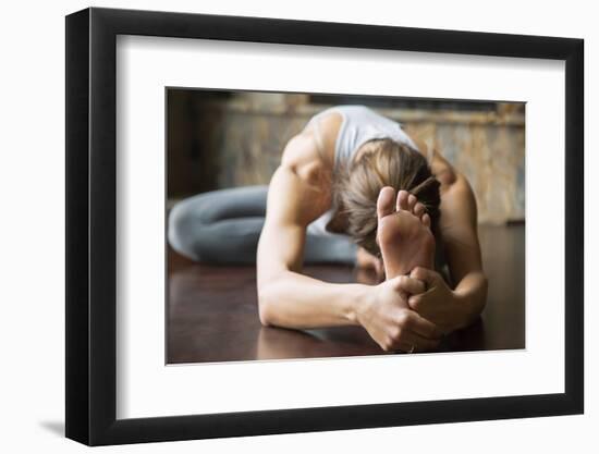 Close up of Young Woman Practicing Yoga, Sitting in Head to Knee Forward Bend Exercise, Janu Sirsas-fizkes-Framed Photographic Print