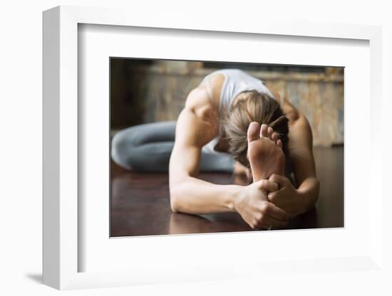 Close up of Young Woman Practicing Yoga, Sitting in Head to Knee Forward Bend Exercise, Janu Sirsas-fizkes-Framed Photographic Print