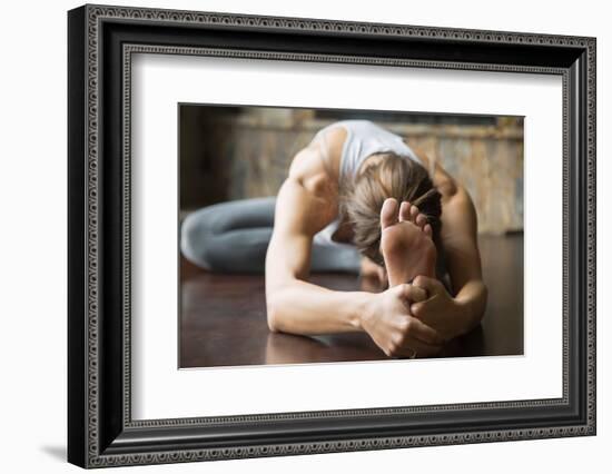 Close up of Young Woman Practicing Yoga, Sitting in Head to Knee Forward Bend Exercise, Janu Sirsas-fizkes-Framed Photographic Print