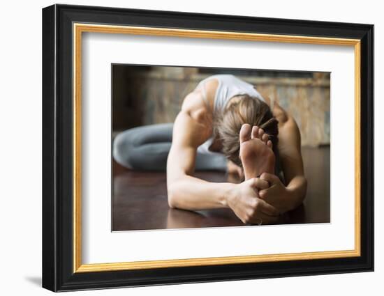 Close up of Young Woman Practicing Yoga, Sitting in Head to Knee Forward Bend Exercise, Janu Sirsas-fizkes-Framed Photographic Print