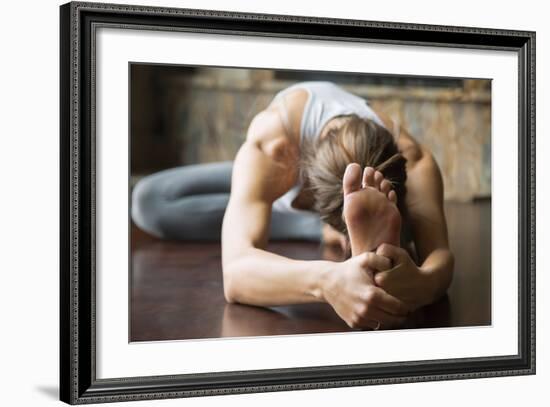 Close up of Young Woman Practicing Yoga, Sitting in Head to Knee Forward Bend Exercise, Janu Sirsas-fizkes-Framed Photographic Print