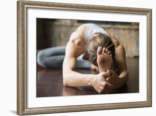 Close up of Young Woman Practicing Yoga, Sitting in Head to Knee Forward Bend Exercise, Janu Sirsas-fizkes-Framed Photographic Print