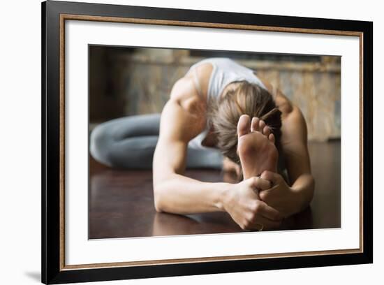 Close up of Young Woman Practicing Yoga, Sitting in Head to Knee Forward Bend Exercise, Janu Sirsas-fizkes-Framed Photographic Print