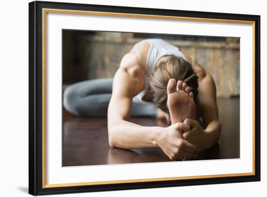 Close up of Young Woman Practicing Yoga, Sitting in Head to Knee Forward Bend Exercise, Janu Sirsas-fizkes-Framed Photographic Print