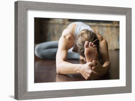 Close up of Young Woman Practicing Yoga, Sitting in Head to Knee Forward Bend Exercise, Janu Sirsas-fizkes-Framed Photographic Print