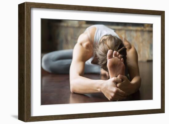 Close up of Young Woman Practicing Yoga, Sitting in Head to Knee Forward Bend Exercise, Janu Sirsas-fizkes-Framed Photographic Print