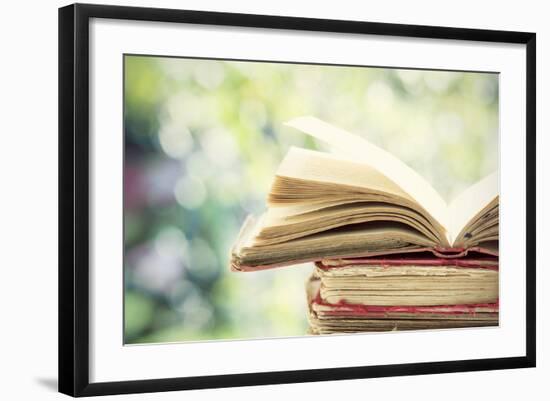 Close up on Old Book on Colorful Bokeh Background-melis-Framed Photographic Print