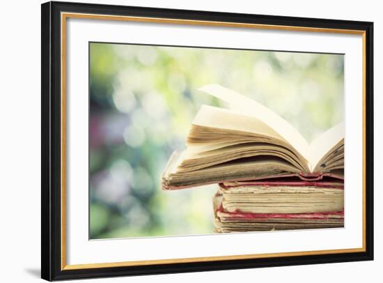 Close up on Old Book on Colorful Bokeh Background-melis-Framed Photographic Print