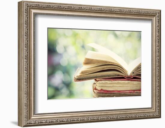 Close up on Old Book on Colorful Bokeh Background-melis-Framed Photographic Print