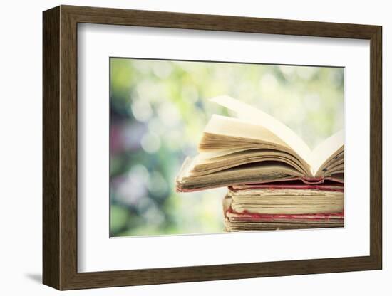 Close up on Old Book on Colorful Bokeh Background-melis-Framed Photographic Print
