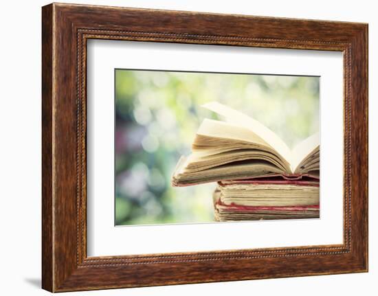 Close up on Old Book on Colorful Bokeh Background-melis-Framed Photographic Print