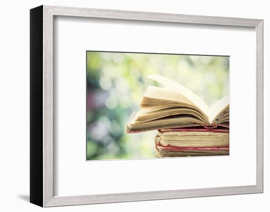 Close up on Old Book on Colorful Bokeh Background-melis-Framed Photographic Print