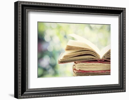 Close up on Old Book on Colorful Bokeh Background-melis-Framed Photographic Print