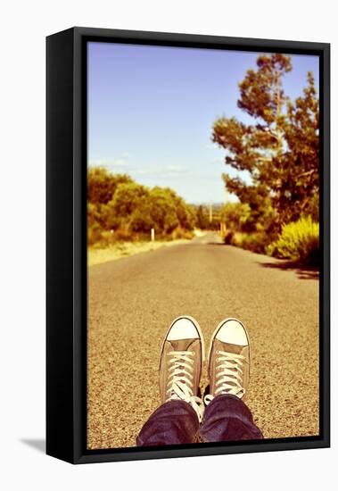 Closeup of the Feet of a Man Lying down on a Road-nito-Framed Premier Image Canvas