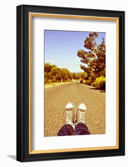 Closeup of the Feet of a Man Lying down on a Road-nito-Framed Photographic Print