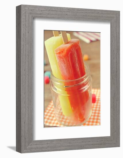 Closeup of Two Appetizing Ice Pops of Different Flavors in a Glass Jar-nito-Framed Photographic Print