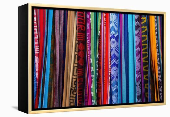 Cloths, Blankets, Scarves, and Hammocks Hang on Display at the Otavalo Market, in Otavalo, Ecuador-Karine Aigner-Framed Premier Image Canvas