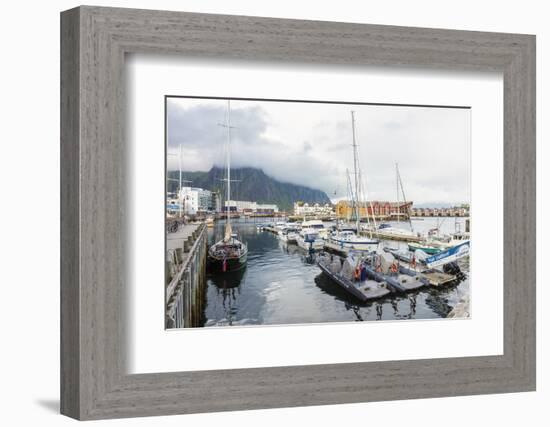 Clouds on rocky peaks frame the boats in the harbor of the fishing village of Svolvaer, Vagan, Lofo-Roberto Moiola-Framed Photographic Print