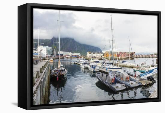 Clouds on rocky peaks frame the boats in the harbor of the fishing village of Svolvaer, Vagan, Lofo-Roberto Moiola-Framed Premier Image Canvas