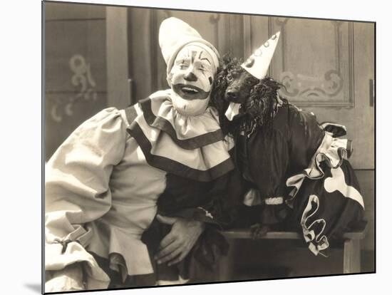 Clown Posing with Dog Dressed in Clown Costume-null-Mounted Photo