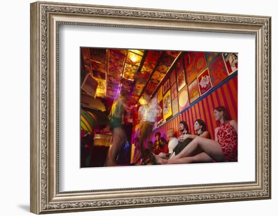 Clubgoers Against a Wall Decorated with Psychedelic Art and Posters, New York, New York, 1967-Yale Joel-Framed Photographic Print