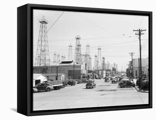 Clusters of Oil Derricks along Street-Philip Gendreau-Framed Premier Image Canvas