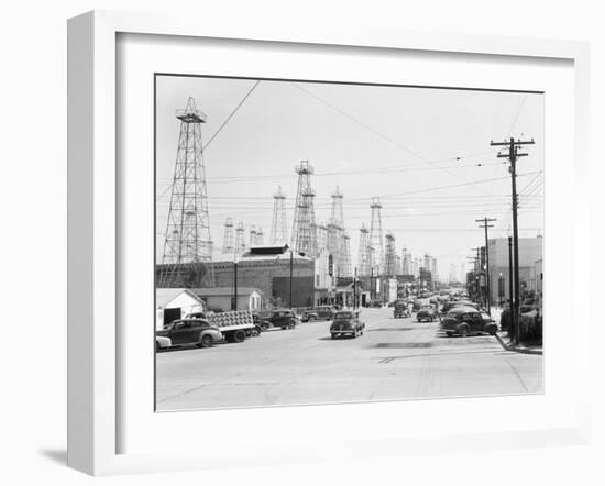 Clusters of Oil Derricks along Street-Philip Gendreau-Framed Photographic Print