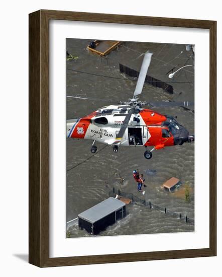 Coast Guard Rescues One from Roof Top of Home, Floodwaters from Hurricane Katrina Cover the Streets-null-Framed Photographic Print